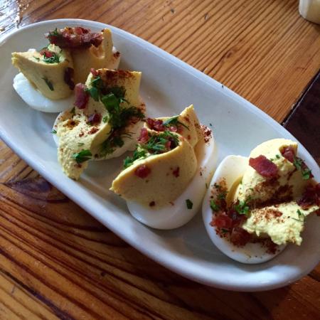 Woodberry Kitchen signature dishes The menu changes with the seasons. Staples include the CMP (Chocolate, Marshmallow, Peanut) dessert, Deviled Eggs, and dishes prepared in its wood-fired oven.